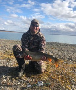 Fishing for lake trout on a caribou hunt