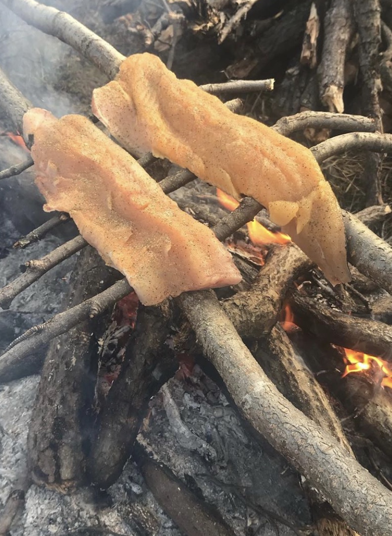 Cooking fish over fire