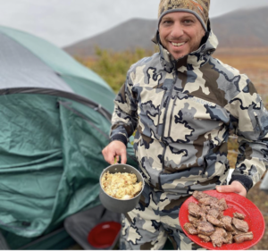 Cooking caribou in camp